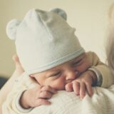 Uncomfortable baby who looks to be experiencing grimacing due to digestive discomfort